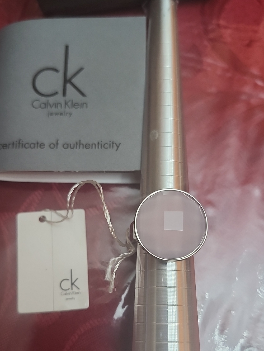 Calvin Klein Silver Band Ring with Pale Pink Stone. Size: 7 3/4
